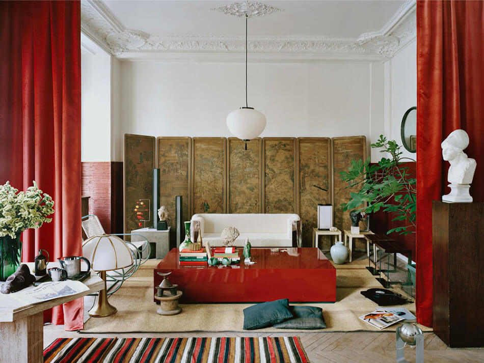 A living room with antique style and pops of red