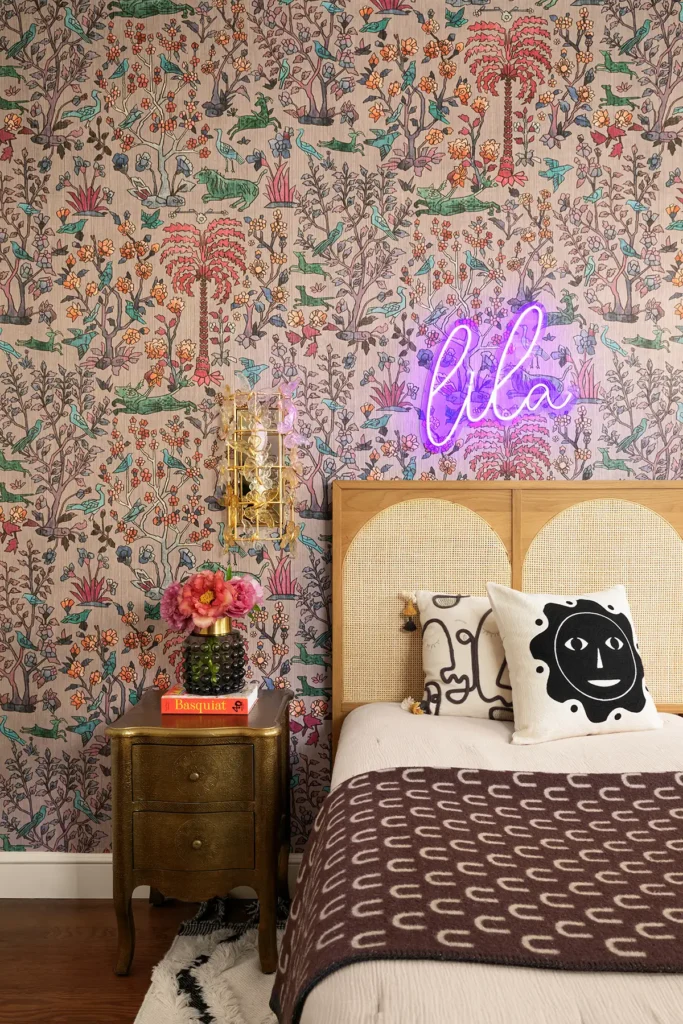 maximalist interior design bedroom with a flowery wallpaper and with a ratan bed and with a bedside table