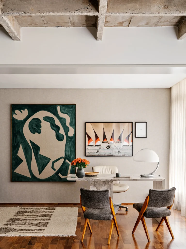 Modernist Apartment study with leather side chairs that face the desk and view to artwork