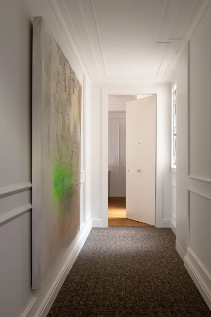 Contemporary Interior Design hallway with white walls and with decorative molding on the wall