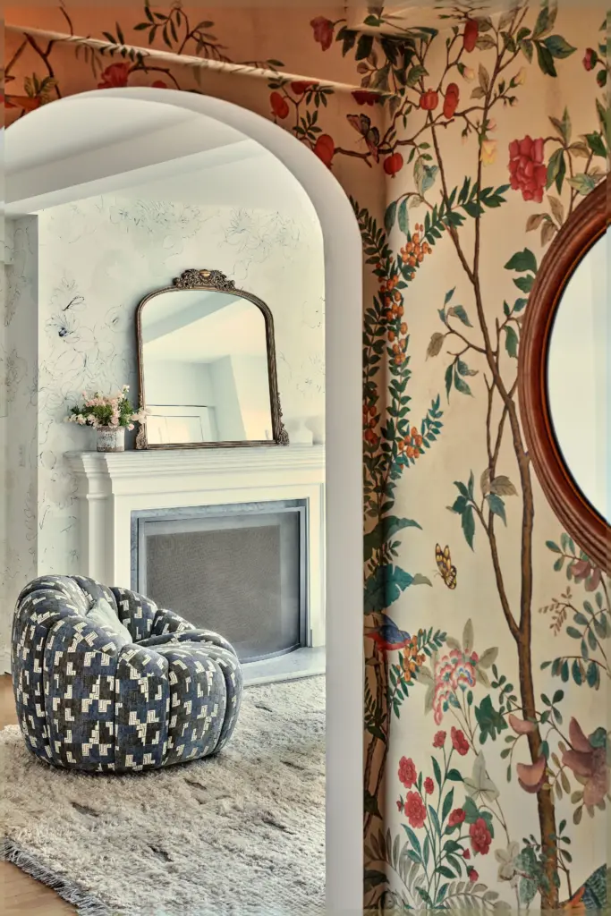 luxury apartment entryway with gucci wallpaper and with a round mirror and with a entry to the living room