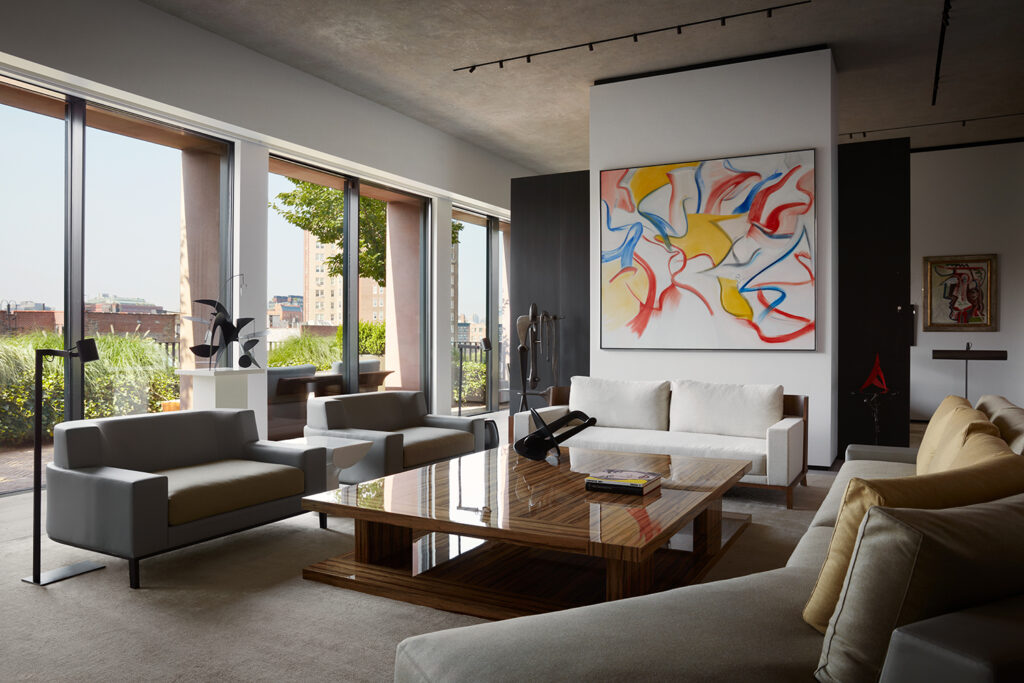 Luxury Interior Design living room with concrete walls and with large windows and with leather sofas and with a square and large wood center table and with a large canvas painting on the main wall