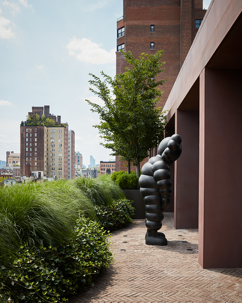 Luxury Interior Design penthouse outdoor with a large KAWS sculpture