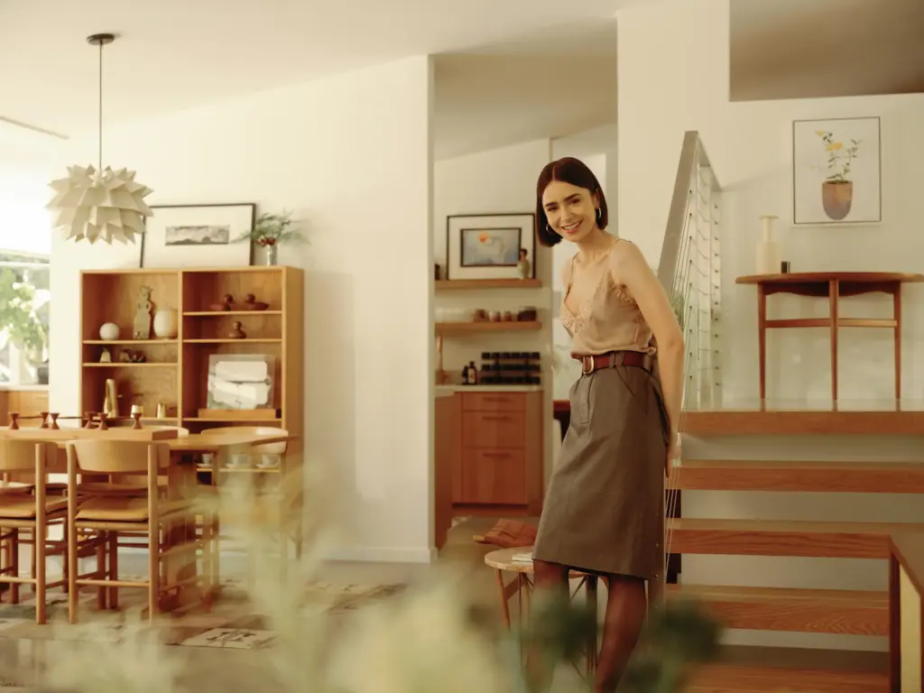 Mid-Century Modern house with clean cream walls and with concrete floors and with a wooden staircase and with a wooden dining table and with wooden dining chairs