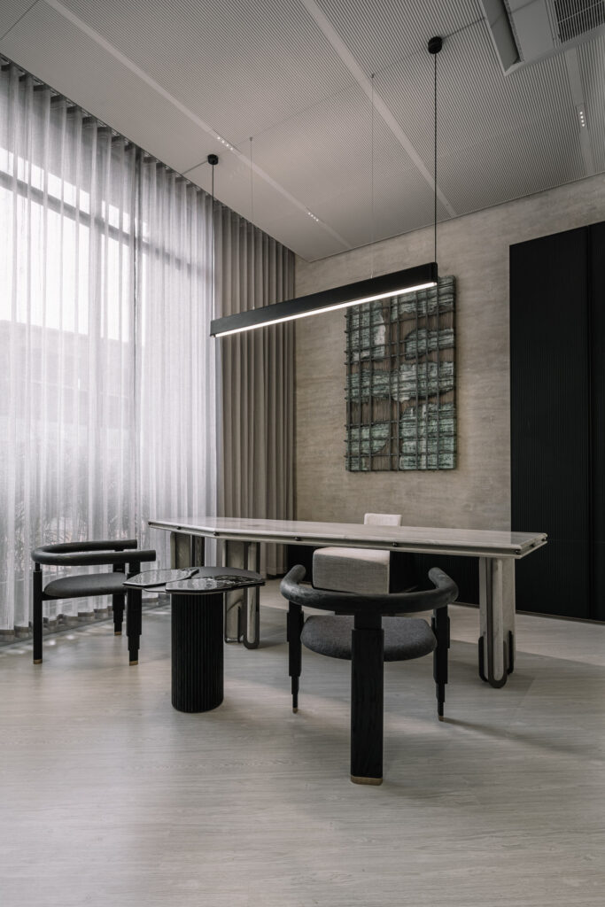 This workspace is a prime example of brutalist design, where stark, industrial elements meet minimalist aesthetics.