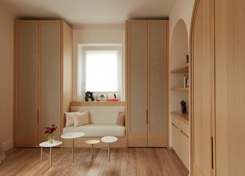 french villa closet with cream walls and with wooden floors and with built-in cabinets and with a built-in bench