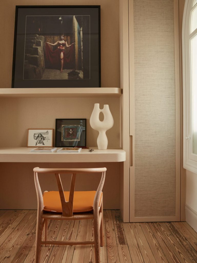 french villa study with built-in cabinet and with a wooden desk and with a wood and orange velvet chair