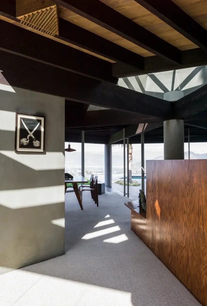 Raw Aesthetics in a living space with a concrete walls and with concrete floors and with wood ceilings and with a wood half wall 