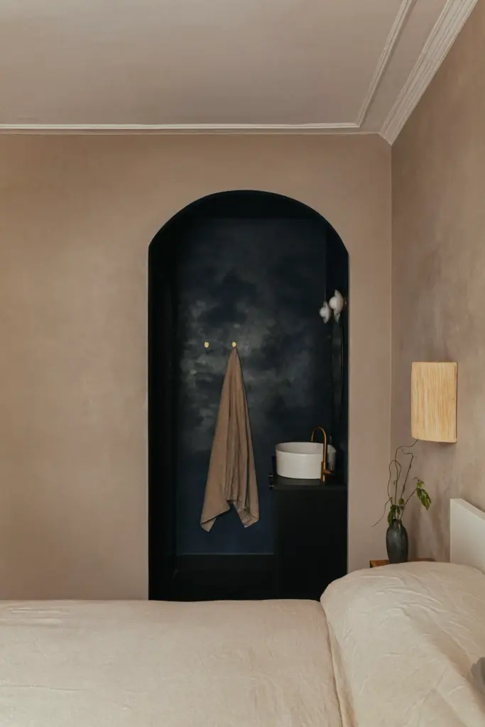 small apartment decor bedroom with an ensuite with dark beige walls and with dark blue walls on the ensuite