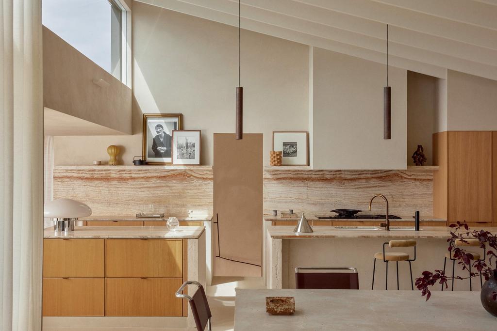 minimalist architecture kitchen with an inclined ceiling and with marble countertops and with wood cabinets and with travertine tables