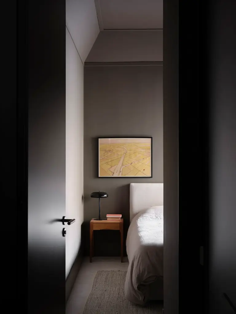 minimalist interior design bedroom with grey walls and with a large bed and with a wooden bedside table