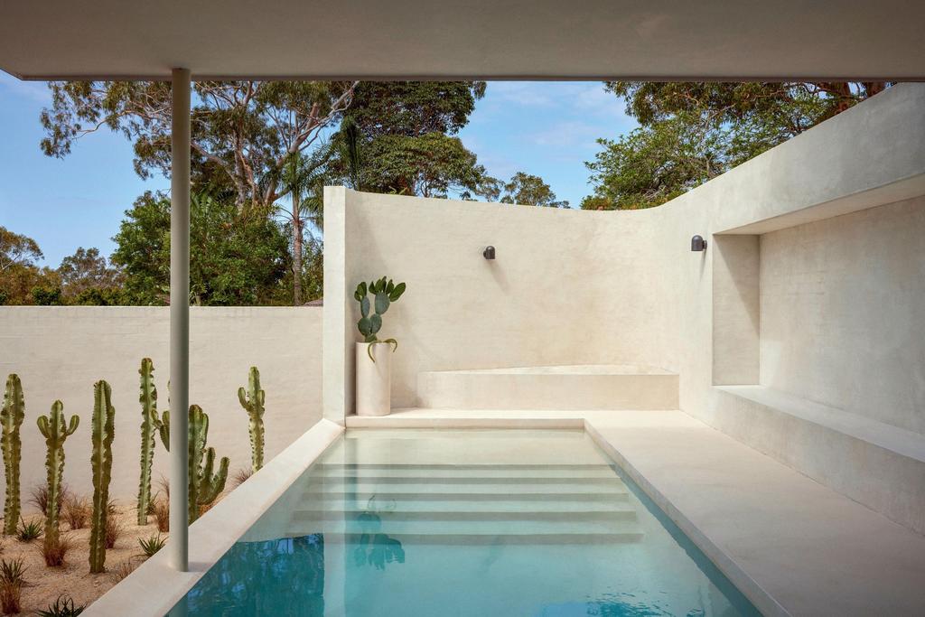 minimalist architecture outdoor area with cement walls and with a large swimming pool