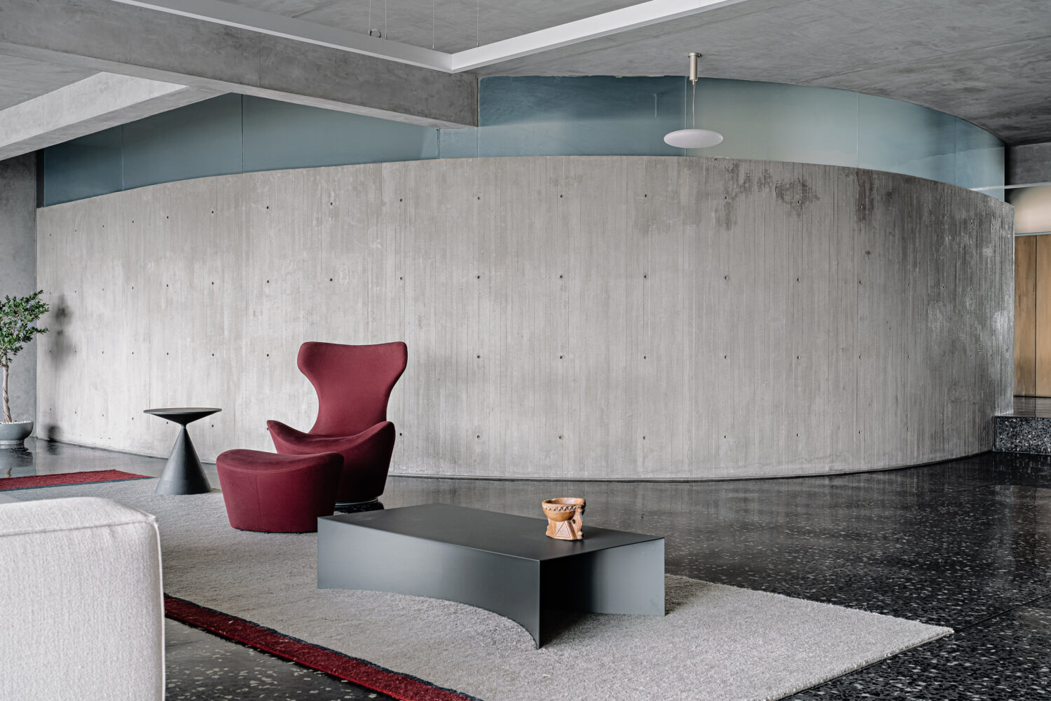 Living room space in the modern penthouse, featuring characteristic red decorative pieces.