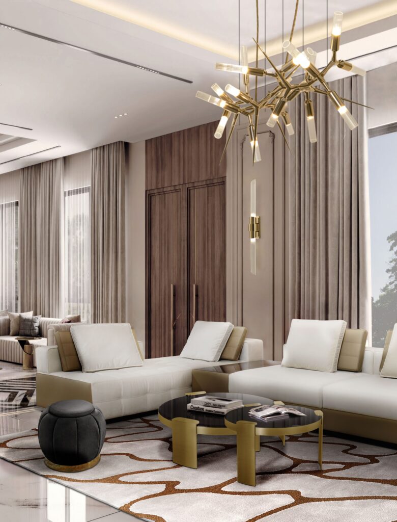 A patterned area rug grounds a modern living room with plush sofas, a unique chandelier, and paneled walls. Elegant and sophisticated space.