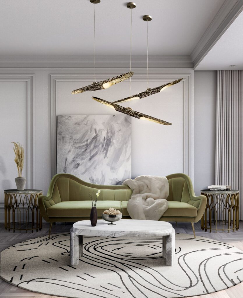 A circular patterned area rug centers a modern living room with a green velvet sofa, marble coffee table, and unique pendant lights. Stylish and chic.