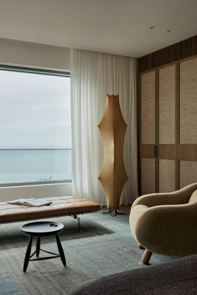 Coastal Home Decor Ideas Inspired by a Cliffside Sydney Residence, bedroom with fantastic ocean view, unique furniture and large window