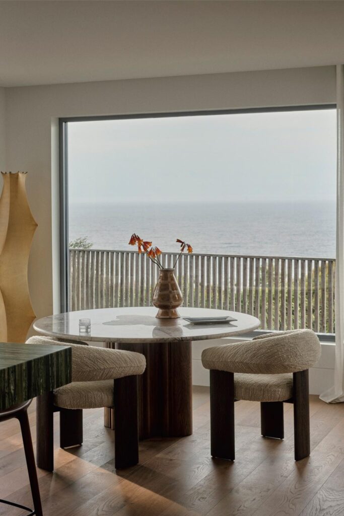 Coastal Home Decor Ideas Inspired by a Cliffside Sydney Residence, dining area with ocean view